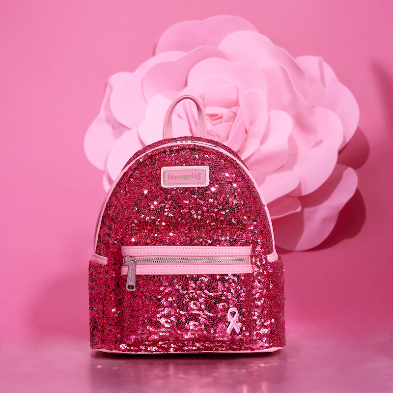 Image of our pink sequin Breast Cancer Research Foundation Mini Backpack against a pink background with a pink flower